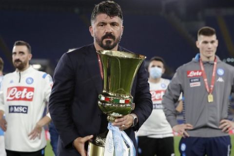 Napoli's head coach Gennaro Gattuso holds the Italian Cup trophy at the end of the final match between Napoli and Juventus, at Rome's Olympic Stadium, Wednesday, June 17, 2020. (AP Photo/Andrew Medichini)