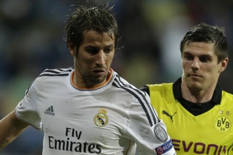 Real's Fabio Coentrao fights for the ball with Dortmund's Jonas Hofmann during a Champions League quarterfinal first leg soccer match between Real Madrid and Borussia Dortmund at the Santiago Bernabeu   stadium in Madrid, Spain, Wednesday April 2, 2014. (AP Photo/Paul White)