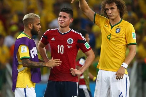 FORTALEZA, BRAZIL - JULY 04:  Dani Alves (L) and David Luiz of Brazil console James Rodriguez of Colombia after Brazil's 2-1 win during the 2014 FIFA World Cup Brazil Quarter Final match between Brazil and Colombia at Castelao on July 4, 2014 in Fortaleza, Brazil.  (Photo by Robert Cianflone/Getty Images)