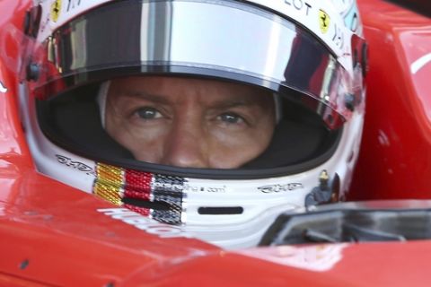 Ferrari driver Sebastian Vettel of Germany arrives at his garage during Pirelli F1 testing in Abu Dhabi, United Arab Emirates, Tuesday, Nov. 27, 2018. (AP Photo/Kamran Jebreili)