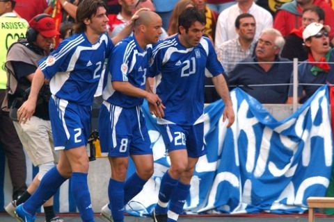 Greece's Georgios Karagounis celebrates scoring the opening goal with teammates Georgios Seitaridis (l) and Stylianos Giannakopoulos (c)