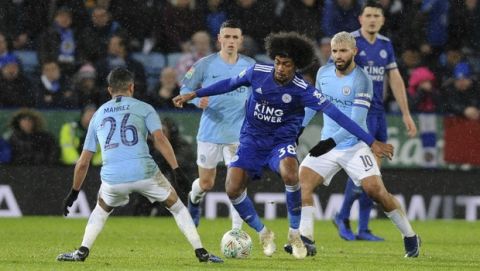 Leicester City's Hamaza Choudhury, centre attempts to get past Manchester City's Riyad Mahrez, left, as Manchester City's Sergio Aguero, right, looks on during the English League Cup quarterfinal soccer match at the King Power stadium in Leicester, England, Tuesday, Dec.18, 2018. (AP Photo/Rui Vieira)