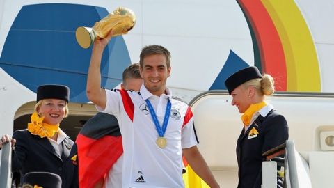 BERLIN, GERMANY - JULY 15: Philipp Lahm holds up the World Cup as the German national team return  after winning the 2014 World Cup at Berlin Tegel Airport on July 15, 2014 in Berlin, Germany.  (Photo by Karina Hessland/Bongarts/Getty Images)
