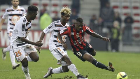 Nice's Jean Michael Seri, right,challenges for the ball with Lorient's Didier Ndong, center and, Lorient's Lamine Gassama during the French League One soccer match between Nice and FC Lorient, Saturday, Jan. 23, 2016, in Nice stadium, southeastern France. (AP Photo/Lionel Cironneau)