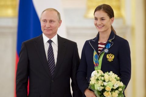 Russian President Vladimir Putin, left, poses with Sofya Velikaya, who won the team sabre fencing gold medal, during an awarding ceremony for Russia's Olympians in the Kremlin in Moscow, Russia, on Thursday, Aug. 25, 2016. (AP Photo/Ivan Sekretarev)