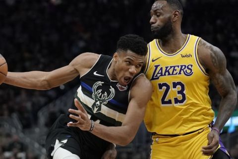 Milwaukee Bucks' Giannis Antetokounmpo tries to drive past Los Angeles Lakers' LeBron James during the second half of an NBA basketball game Thursday, Dec. 19, 2019, in Milwaukee. The Bucks won 111-104. (AP Photo/Morry Gash)