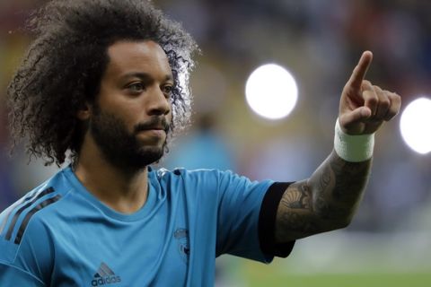 Real Madrid's Marcelo points as he warms up ahead of the Champions League Final soccer match between Real Madrid and Liverpool at the Olimpiyskiy Stadium in Kiev, Ukraine, Saturday, May 26, 2018. (AP Photo/Sergei Grits)