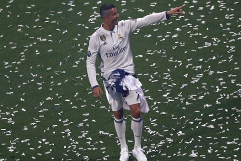 Real Madrid's Cristiano Ronaldo gestures to supporters as he celebrates with the rest of the team after winning the Champions League final, at the Santiago Bernabeu stadium in Madrid, Spain, Sunday, June 4, 2017. Real Madrid became the first team in the Champions League era to win back-to-back titles with their 4-1 victory over Juventus in Cardiff, Wales, on Saturday. (AP Photo/Francisco Seco)