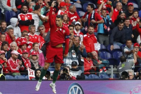 Portugal's Cristiano Ronaldo celebrates after scoring his side's opening goal during the UEFA Nations League semifinal soccer match between Portugal and Switzerland at the Dragao stadium in Porto, Portugal, Wednesday, June 5, 2019. (AP Photo/Armando Franca)