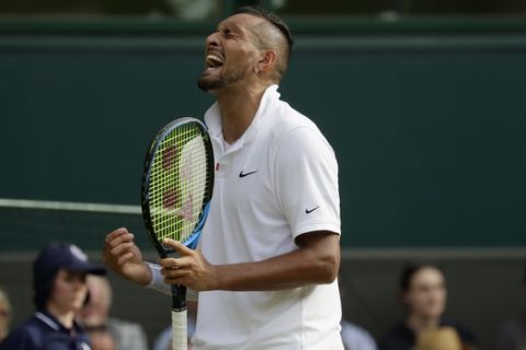 Australia's Nick Kyrgios reacts after winning a point against Spain's Rafael Nadal in a Men's singles match during day four of the Wimbledon Tennis Championships in London, Thursday, July 4, 2019. (AP Photo/Kirsty Wigglesworth)