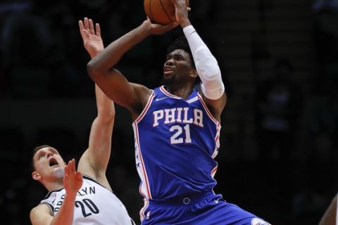 Philadelphia 76ers center Joel Embiid (21) shoots next to Brooklyn Nets center Timofey Mozgov (20) during the third quarter of a preseason NBA basketball game, Wednesday, Oct. 11, 2017, in Uniondale, N.Y. (AP Photo/Julie Jacobson)