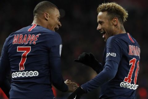 PSG's Kylian Mbappe, left, reacts with PSG's Neymar, celebrating after he scored his side's second goal during the League One soccer match between Paris Saint-Germain and Lille at the Parc des Princes stadium in Paris, Friday, Nov. 2, 2018. (AP Photo/Thibault Camus)