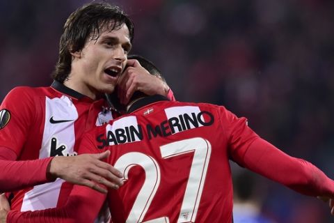Athletic Bilbao's Sabin Merino, right, is congratulated by his fellow teammate Ander Iturrasper after scoring his goal during the Europa League soccer match, round of 32, second leg, between Athletic Bilbao and Olympique de Marseille, at San Mames stadium, in Bilbao, northern Spain, Thursday, Feb. 25, 2016. (AP Photo/Alvaro Barrientos)