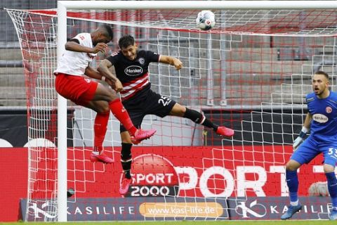 FC Cologne's Anthony Modeste scores their first goal during a German Bundesliga soccer match between 1. FC Cologne and Fortuna Duesseldorf in Cologne, Germany, Sunday, May 24, 2020.  (Thilo Schmuelgen/pool via AP)