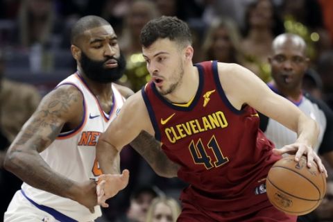 Cleveland Cavaliers' Ante Zizic, right, from Croatia, drives past New York Knicks' Kyle O'Quinn in the second half of an NBA basketball game, Wednesday, April 11, 2018, in Cleveland. (AP Photo/Tony Dejak)