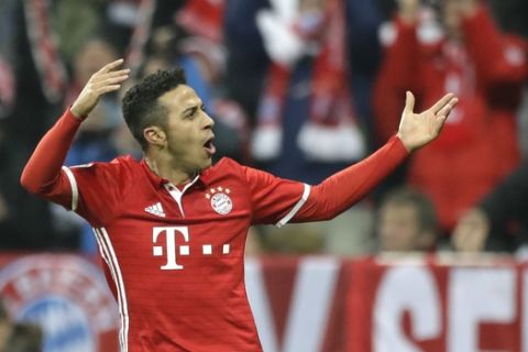 Bayern's Thiago Alcantara celebrates after scoring his side's fourth goal during the Champions League round of 16 first leg soccer match between FC Bayern Munich and Arsenal, in Munich, Germany, Wednesday, Feb. 15, 2017. (AP Photo/Matthias Schrader)