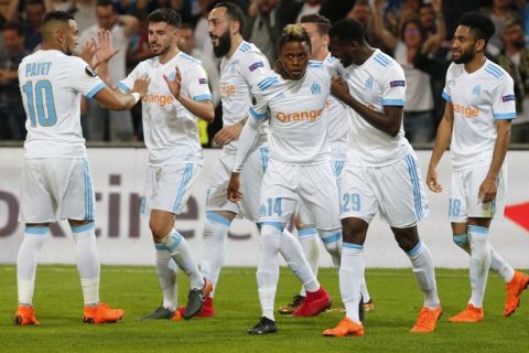 Marseille's Clinton N'Jie, center, celebrates with team mates after scoring his side's second goal during the Europa League semifinal first leg soccer match between Olympique Marseille and RB Salzburg at the Velodrome stadium in Marseille, France, Thursday, April 26, 2018. (AP Photo/Thibault Camus)