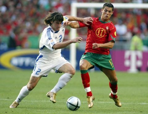 epa000226578 Portugal's Cristiano Ronaldo(R) fights for the ball with Greek Giourkas Seitaridis during  the EURO 2004 Final between  Portugal and Greece at Luz stadium in Lisbon on Sunday 04 July 2004.  EPA/PAULO CARRICO NO MOBIL APPLICATIONS