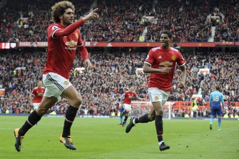Manchester United's Marouane Fellaini, left, celebrates after scoring his side's second goal during the English Premier League soccer match between Manchester United and Arsenal at the Old Trafford stadium in Manchester, England, Sunday, April 29, 2018. (AP Photo/Rui Vieira)