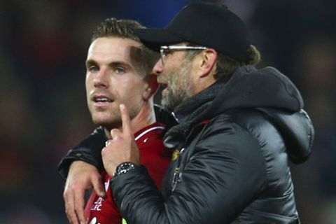Liverpool midfielder Jordan Henderson, left, chats with Liverpool coach Juergen Klopp after the Champions League Group C soccer match between Liverpool and Napoli at Anfield stadium in Liverpool, England, Tuesday, Dec. 11, 2018.(AP Photo/Dave Thompson)