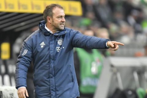 Bayern's manager Hansi Flick gestures during the German Bundesliga soccer match between Borussia Moenchengladbach and Bayern Munich at the Borussia Park in Moenchengladbach, Germany, Saturday, Dec. 7, 2019. (AP Photo/Martin Meissner)