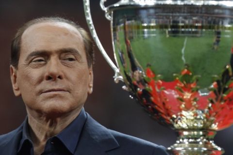 Italian Premier Silvio Berlusconi attends the presentation of the 'Berluscon trophy'  after a
 soccer match betweeen AC Milan and Juventus  at the San Siro stadium in Milan, Italy, Sunday, Aug.21, 2011. (AP Photo/Luca Bruno)