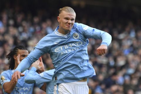 Manchester City's Erling Haaland celebrates after scoring his side's opening goal during the English Premier League soccer match between Manchester City and Liverpool at Etihad stadium in Manchester, England, Saturday, Nov. 25, 2023. (AP Photo/Rui Vieira)