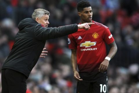 Manchester United manager Ole Gunnar Solskjaer talks to Manchester United's Marcus Rashford during the English Premier League soccer match between Manchester United and West Ham United at Old Trafford in Manchester, England, Saturday, April 13, 2019. (AP Photo/Rui Vieira)