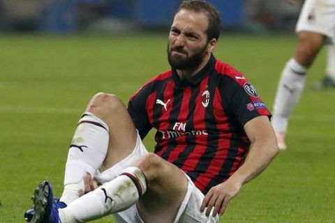 AC Milan's Gonzalo Higuain grimaces in pain during the Europa League, Group F soccer match between AC Milan and Betis, at the San Siro Stadium in Milan, Italy, Thursday, Oct. 25, 2018. (AP Photo/Antonio Calanni)