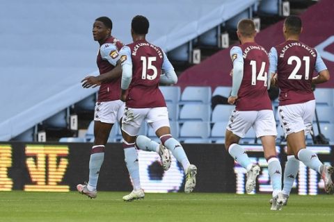 Aston Villa's Kortney Hause, left, celebrates after scoring his side's opening goal during the English Premier League soccer match between Aston Villa and Chelsea at the Villa Park stadium in Birmingham, England, Sunday, June 21, 2020. (Cath Ivill/Pool via AP)