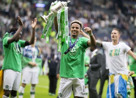 Celtic's Scott Sinclair holds up the trophy after the Scottish Cup final against Aberdeen at Hampden Park, Glasgow, Scotland, Saturday, May 27, 2017. (Jeff Holmes/PA via AP)