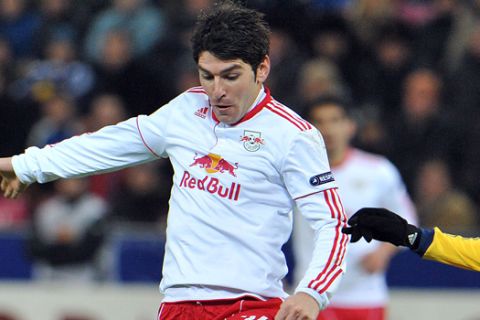 Salzburg's Jonathan Soriano from Spain, left, and  Metalist Kharkiv's Papa Gueye challenge for the ball  during their Europa League round of 32, first leg soccer match between Red Bull Salzburg and  Metalist Kharkiv in Salzburg, Austria, Thursday , Feb. 16, 2012. (AP Photo/ Kerstin Joensson)