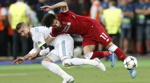 Real Madrid's Sergio Ramos, left, fouls Liverpool's Mohamed Salah during the Champions League Final soccer match between Real Madrid and Liverpool at the Olimpiyskiy Stadium in Kiev, Ukraine, Saturday, May 26, 2018. (AP Photo/Efrem Lukatsky)