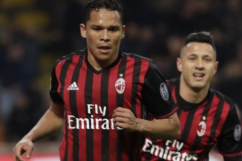 AC Milan's Carlos Bacca, left, celebrates with his teammate Gianluca Lapadula after scoring his side's second goal during a Serie A soccer match between AC Milan and Chievo Verona, at the San Siro stadium in Milan, Italy, Saturday, March 4, 2017. (AP Photo/Luca Bruno)