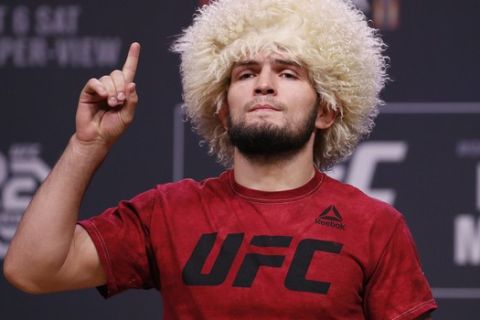 FILE - In this Oct. 5, 2018, file photo, Khabib Nurmagomedov poses during a ceremonial weigh-in for the UFC 229 mixed martial arts fight in Las Vegas. Nevada fight regulators postponed until next month hearings on suspensions against UFC fighters Conor McGregor and Khabib Nurmagomedov for a brawl after their October match in Las Vegas. (AP Photo/John Locher, File)
