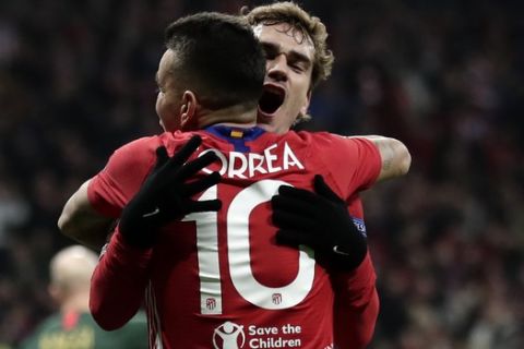Atletico forward Antoine Griezmann, background, celebrates with his teammate Angel Correa after scoring his side's second goal during a Group A Champions League soccer match between Atletico Madrid and Monaco at the Metropolitano stadium in Madrid, Wednesday, Nov. 28, 2018. (AP Photo/Manu Fernandez)