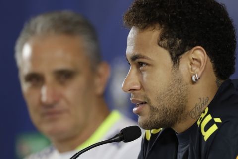 Brazil's Neymar, right, speaks as coach Tite listens onduring a press conference after a training session in Sao Paulo, Brazil, Monday, March 27, 2017. Brazil will face Paraguay in a 2018 World Cup qualifying soccer match on March 28. (AP Photo/Andre Penner)