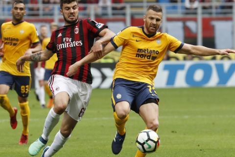 AC Milan's Patrick Cutrone, left, challenges for the ball with Verona's Thomas Heurtaux during the Serie A soccer match between AC Milan and Hellas Verona at the San Siro stadium in Milan, Italy, Saturday, May 5, 2018. (AP Photo/Antonio Calanni)