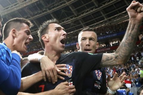 Croatia's Mario Mandzukic, center, celebrates after scoring his side's second goal during the semifinal match between Croatia and England at the 2018 soccer World Cup in the Luzhniki Stadium in Moscow, Russia, Wednesday, July 11, 2018. (AP Photo/Frank Augstein)