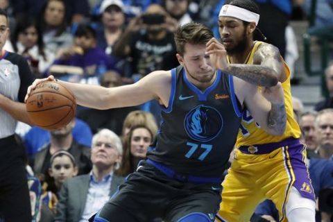 Dallas Mavericks forward Luka Doncic (77), of Germany, dribbles against Los Angeles Lakers forward Brandon Ingram (14) during the first quarter of an NBA basketball game in Dallas, Monday, Jan. 7, 2019. (AP Photo/LM Otero)