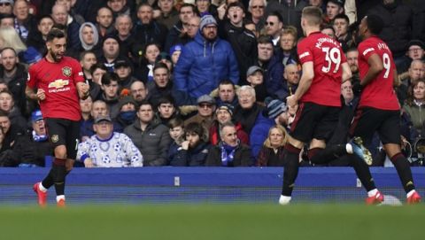 Manchester United's Bruno Fernandes, left, celebrates after scoring his side's first goal during the English Premier League soccer match between Everton and Manchester United at Goodison Park in Liverpool, England, Sunday, March 1, 2020. (AP Photo/Jon Super)