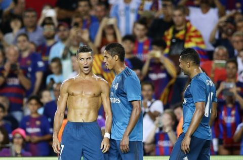 Real Madrid's Cristiano Ronaldo, left, celebrates after scoring during the Spanish Supercup, first leg, soccer match between FC Barcelona and Real Madrid at the Camp Nou stadium in Barcelona, Spain, Sunday, Aug. 13, 2017. (AP Photo/Manu Fernandez)