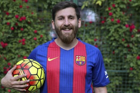 In this May 8, 2017 photo, Reza Parastesh Iranian doppelganger or look-alike, of Argentinian soccer legend Lionel Messi, poses for a photo in an urban soccer field in Tehran, Iran. (AP Photo/Ebrahim Noroozi)