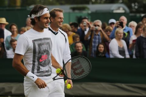 Roger Federer of Switzerland attends a practice session with his coach Stefan Edberg, right, at the All England Lawn Tennis Championships at Wimbledon, London, Saturday July 5, 2014. Federer will play in the men's singles final against Novak Djokovic of Serbia on Sunday. (AP Photo/Ben Curtis)