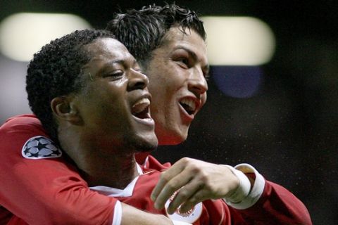Manchester United's Patrice Evra, left, celebrates with Cristiano Ronaldo after scoring the seventh goal against Roma during their Champions League quarter final second-leg soccer match at Old Trafford Stadium, Manchester, England, Tuesday April 10, 2007. (AP Photo/Jon Super)