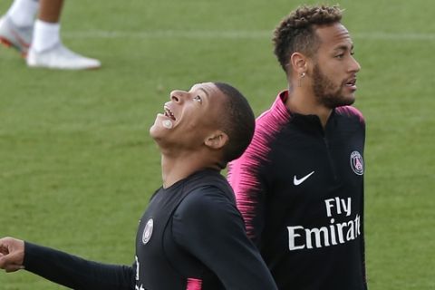 PSG's Kylian Mbappe , left, trains with Neymar during a training session at the club training center in Saint Germain en Laye, west of Paris, Friday, Aug.24, 2018. Paris Saint Germain will play Angers Saturday in a French League One match. (AP Photo/Michel Euler)