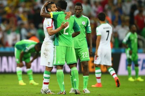 CURITIBA, BRAZIL - JUNE 16:  Reza Ghoochannejhad of Iran reacts with Joseph Yobo of Nigeria after their draw during the 2014 FIFA World Cup Brazil Group F match between Iran and Nigeria at Arena da Baixada on June 16, 2014 in Curitiba, Brazil.  (Photo by Clive Rose/Getty Images)
