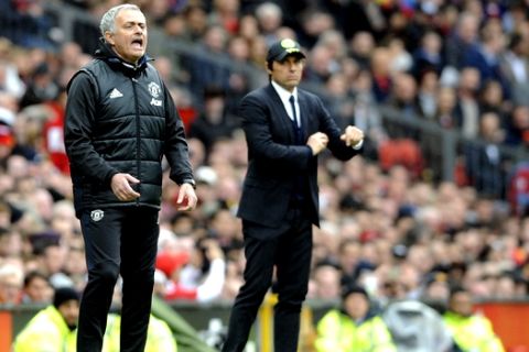 Manchester United's team manager Jose Mourinho, left, and Chelsea's team manager Antonio Conte react during the English Premier League soccer match between Manchester United and Chelsea at Old Trafford stadium in Manchester, Sunday, April 16, 2017.(AP Photo/ Rui Vieira)