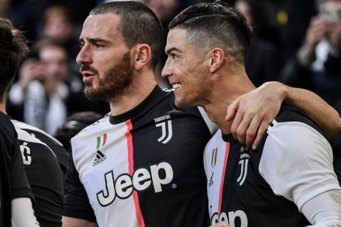 Juventus' Cristiano Ronaldo celebrates with teammate Gonzalo Higuain after scoring during an Italian Serie A soccer match between Juventus and Cagliari at the Allianz Stadium in Turin, Italy, Monday, Jan. 6, 2020. (Marco Alpozzi/LaPresse via AP)