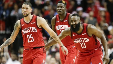 Houston Rockets guard James Harden (13) congratulates guard Austin Rivers (25) after Rivers' three-point basket late in the second half of an NBA basketball game against the Oklahoma City Thunder, Tuesday, Dec. 25, 2018, in Houston. Houston won 113-109. (AP Photo/Eric Christian Smith)
